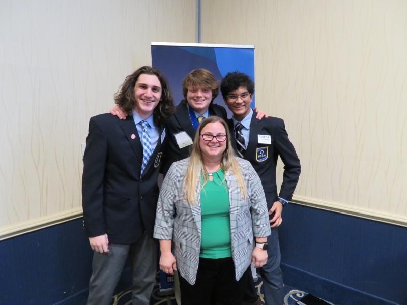 Former Cape High teacher Kimberly Bailey-Thomas, center, now works at Delaware Technical Community College and is the state DECA advisor. Bailey-Thomas was able to catch up with Cape students (l-r) Andrew Racz, Cape DECA Vice President of Leadership Wiley Owens and Cape DECA Vice President Krish Prattipati.